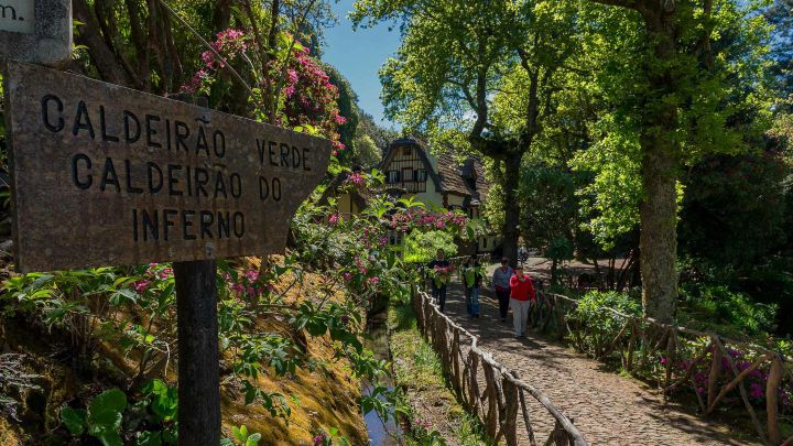Levada path and traditional Queimadas house on PR9 Levada do Caldeirão Verde, Madeira